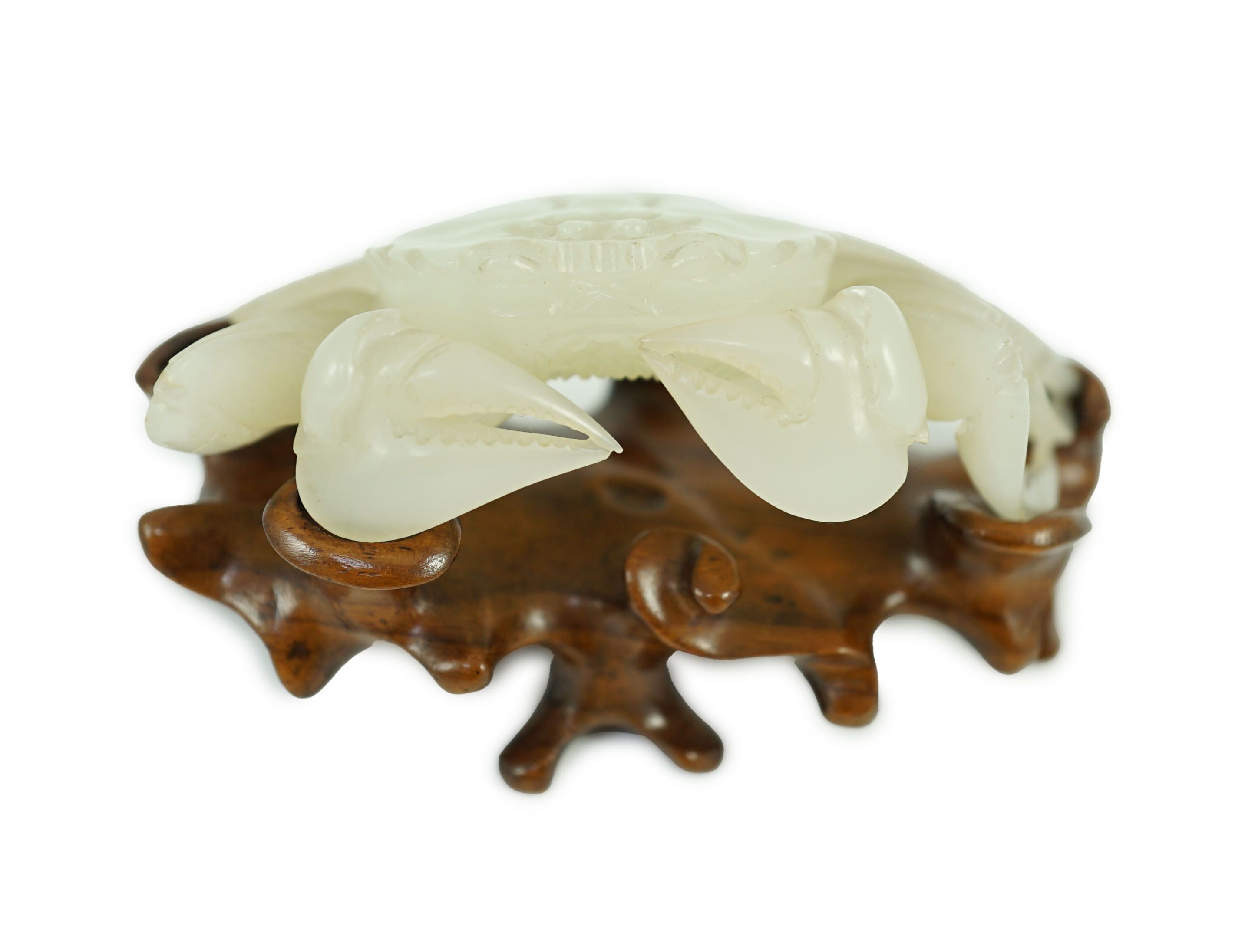 A Chinese pale celadon jade model of a crab, 20th century, 8.4 cm wide, wood stand